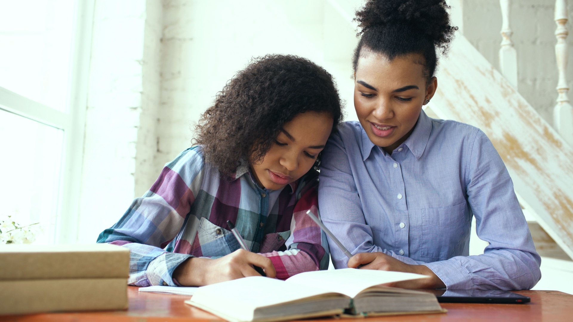 Child journaling with an open Bible